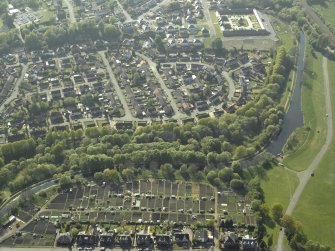 Oblique aerial view of the canal and housing with the farmsteading adjacent, taken from the E.