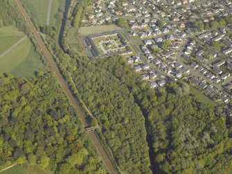 Oblique aerial view of the canal, housing and farmsteading, taken from the WNW.