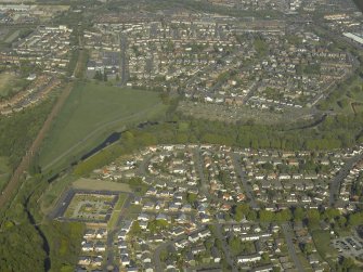 General oblique aerial view of the canal, housing and farmsteading, taken from the W.