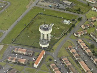 Oblique aerial view centred on the water tower, taken from the NE.