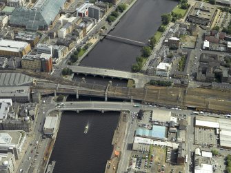 Oblique aerial view centred on the railway bridge and road bridges, taken from the W.
