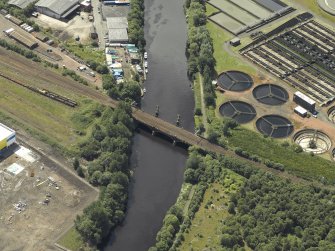 Oblique aerial view centred on the remains of the bridge with Western Railway Bridge adjacent, taken from the ENE.