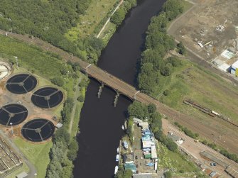 Oblique aerial view centred on the remains of the bridge with Western Railway Bridge adjacent, taken from the SW.