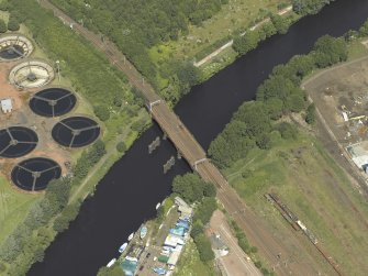 Oblique aerial view centred on the remains of the bridge with Western Railway Bridge adjacent, taken from the SSW.