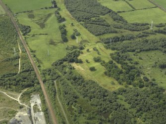 General oblique aerial view centred on the remains of the Roman fort and the course of the Antonine Wall, taken from the ESE.
