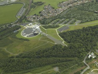 Oblique aerial view centred on the Millenuim Wheel and canal, taken from the SW.