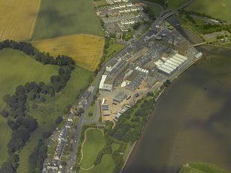 Oblique aerial view centred on the town and paper mill, taken from the SE.