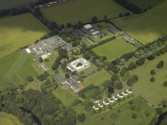 Oblique aerial view centred on the HQ building with Craigiehall House, barracks and married quarters adjacent, taken from the SW.