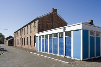 View, showing barrack block and modern single storey portacabin type extension block.