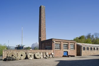View showing boiler house, chimney and garage from NW