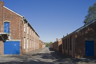 View showing S-facing barrack blocks with store huts on right from W.