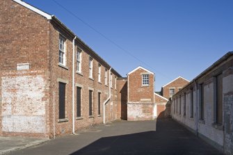 View showing space between barrack block and store hut from W.