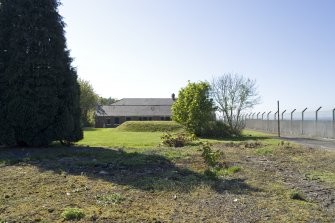 View from NW showing emergency exit hatch and S-shaped mound of shelter.