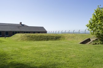 View from SW showing entrnace to shelter with earth mound in background.