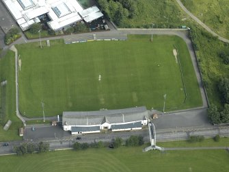 Oblique aerial view centred on rugby ground, taken from the W.