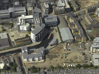 Oblique aerial view centred on the canal terminus with the new developments at Edinburgh Quay adjacent, taken from the S.