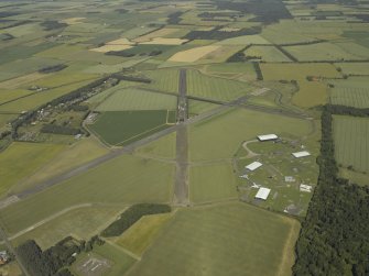 Oblique aerial view centred on the airfield with the Museum of Flight adjacent, taken from the W.