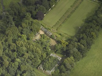 Oblique aerial view centred on the stables with the walled garden adjacent, taken from the SW.