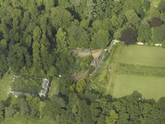 Oblique aerial view centred on the stables with the walled garden adjacent, taken from the SW.
