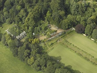 Oblique aerial view centred on the stables with the walled garden adjacent, taken from the S.