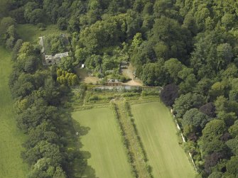 Oblique aerial view centred on the stables with the walled garden adjacent, taken from the SE