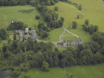 Oblique aerial view centred on the ruins of the house, taken from the NE.