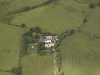 Oblique aerial view centred on the farmsteading, taken from the S.