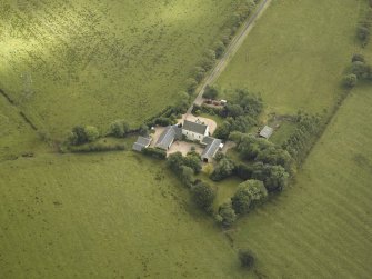 Oblique aerial view centred on the farmsteading, taken from the NE.