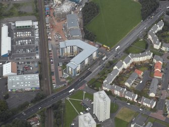 Oblique aerial view centred on Drybrough Crescent showing second phase of new housing development under construction, taken from the SW.