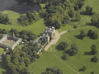Oblique aerial view centred on the country house and stables, taken from the W.