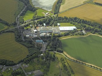 Oblique aerial view centred on the paper mill, taken from the N.