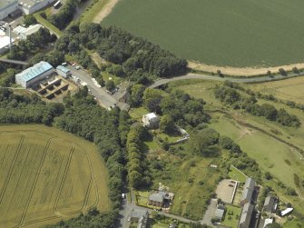 Oblique aerial view centred on the house with the paper mill filter beds adjacent, taken from the NE.