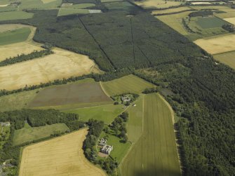 Oblique aerial view centred on the house, taken from the W.