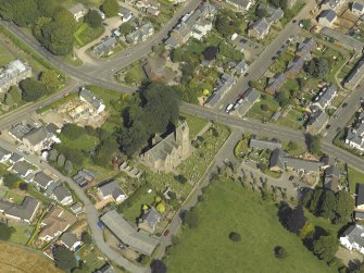 Oblique aerial view of Newtyle village centred on the Church, taken from the SW.