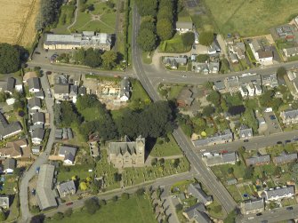 Oblique aerial view of Newtyle village centred on the Church, taken from the SSE.