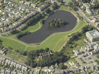 Oblique aerial view centred on the reservoir with the water tower and high school adjacent, taken from the ESE.