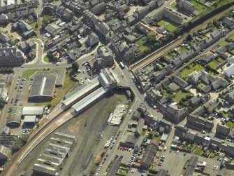 Oblique aerial view centred on the station with the goods shed adjacent, taken from the N.