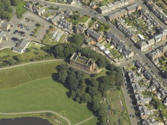 Oblique aerial view centred on the water tower with the high school adjacent, taken from the SW.