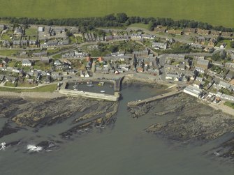 Oblique aerial view centred on the harbour with the town adjacent, taken from the SE.