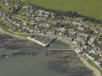 Oblique aerial view centred on the harbour with the town adjacent, taken from the E.