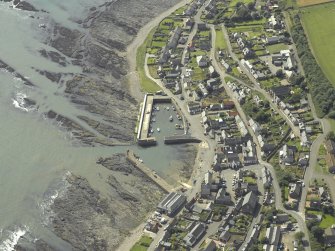 Oblique aerial view centred on the harbour and town, taken from the NE.