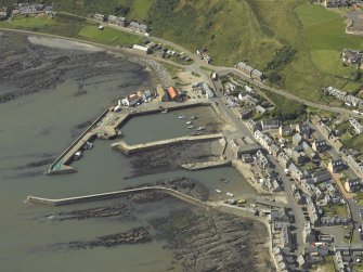 Oblique aerial view centred on the harbour, taken from the E.