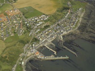 General oblique aerial view centred on the harbour and village, taken from the SW.