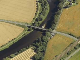 Oblique aerial view centred on the road bridge and the tollhouse, taken from the NW.