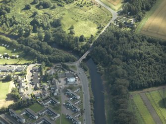 Oblique aerial view centred on the road bridge, taken from the NW.