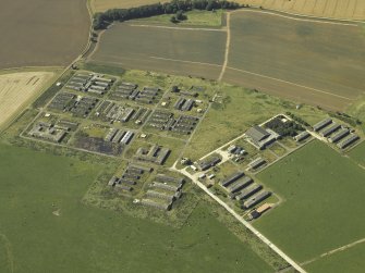 Oblique aerial view centred on the accommodation camp, taken from the SE.