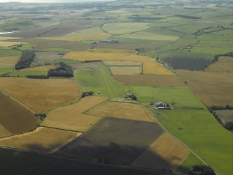 General oblique aerial view looking towards the airfield with the farmsteads of Sorbie and Kingsmuir adjacent, taken from the E.