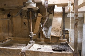 Interior. Ground floor. Sieve, note the shutes from the shelling (left) and the grinding stones (right).