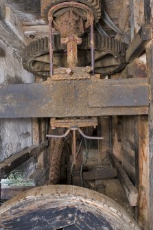 Interior. Ground floor. Gear Cupboard. View of bevel pit wheel, wallower, great spur wheel, upright shaft and stone nut for shelling stones top of image.