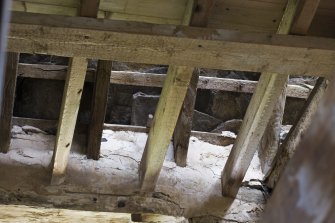 Interior. View of floor beams and wall head and roof.